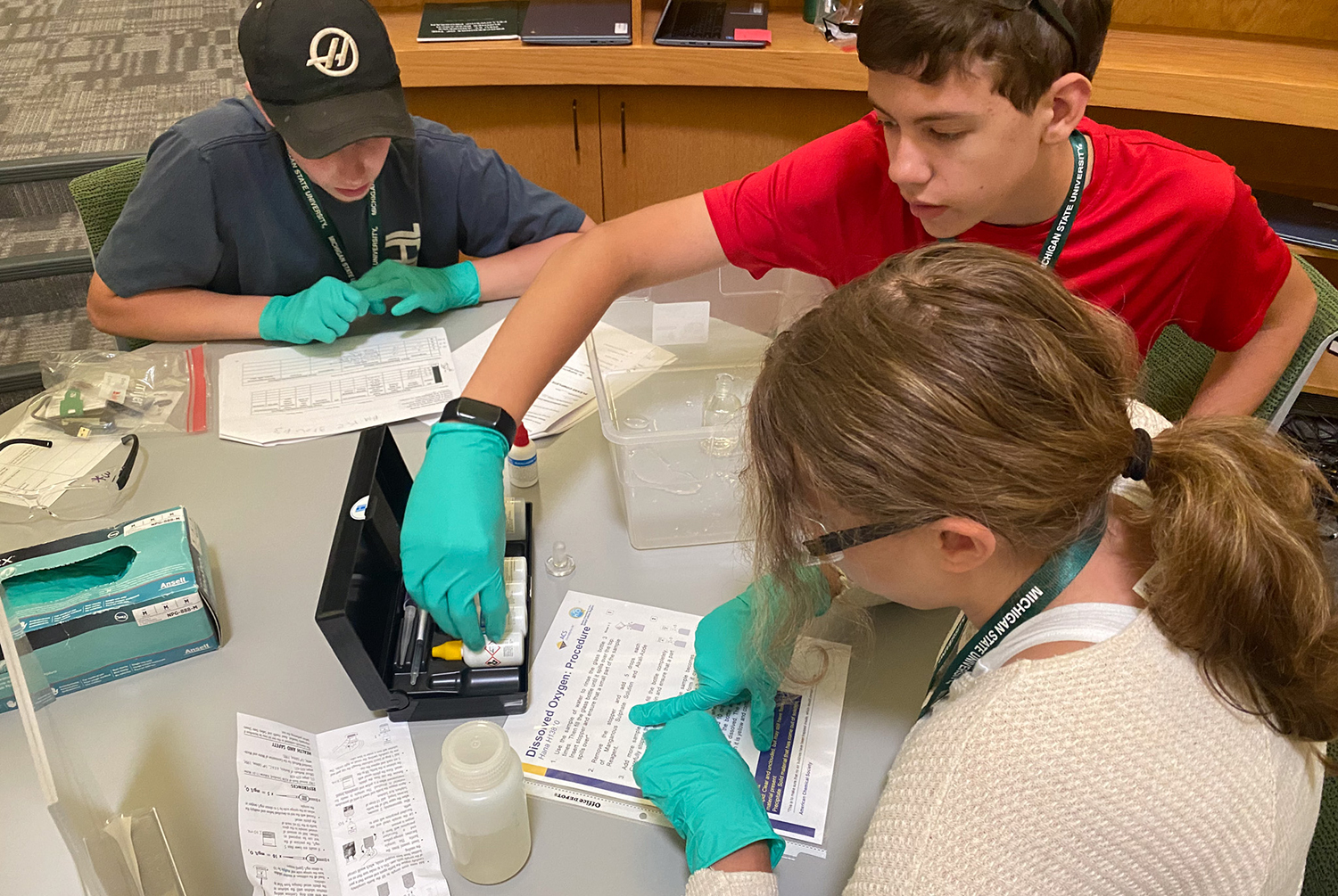Three middle grade youth working together on project