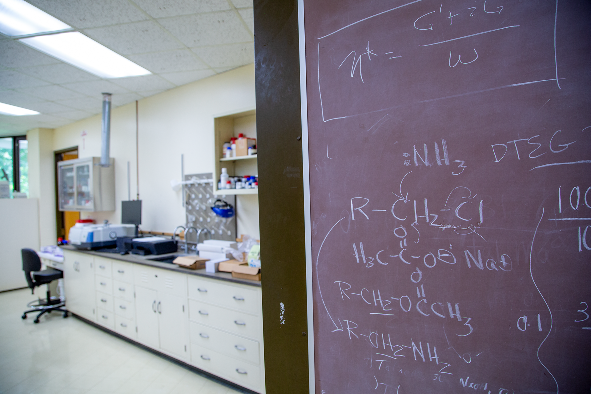 A blackboard in a lab with chemical formulas written on it