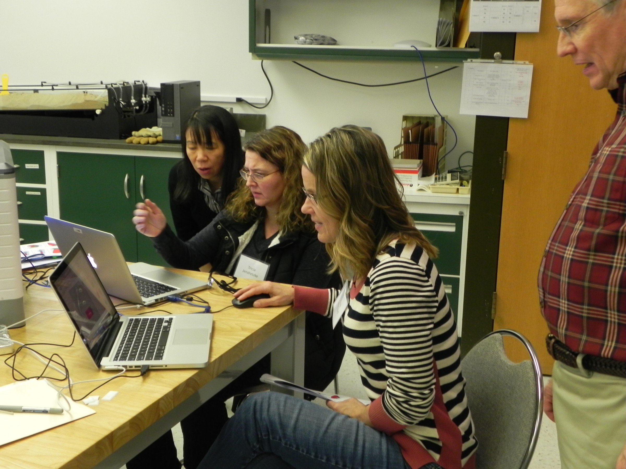 Teachers gathered around a computer