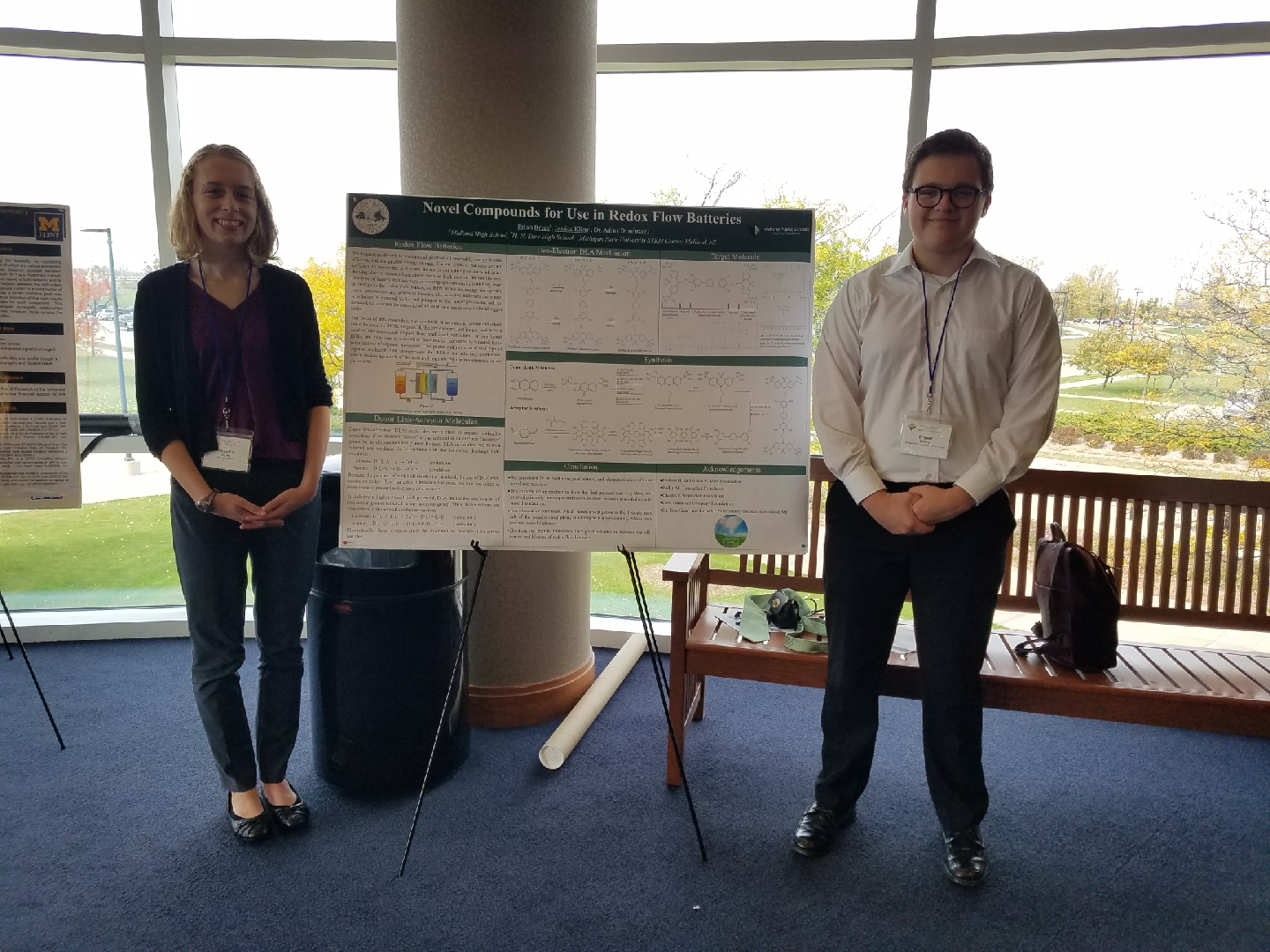 Two students present poster at a conference