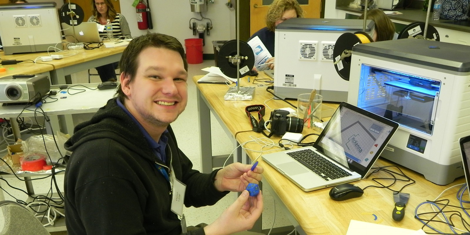 Teacher using 3D printing equipment