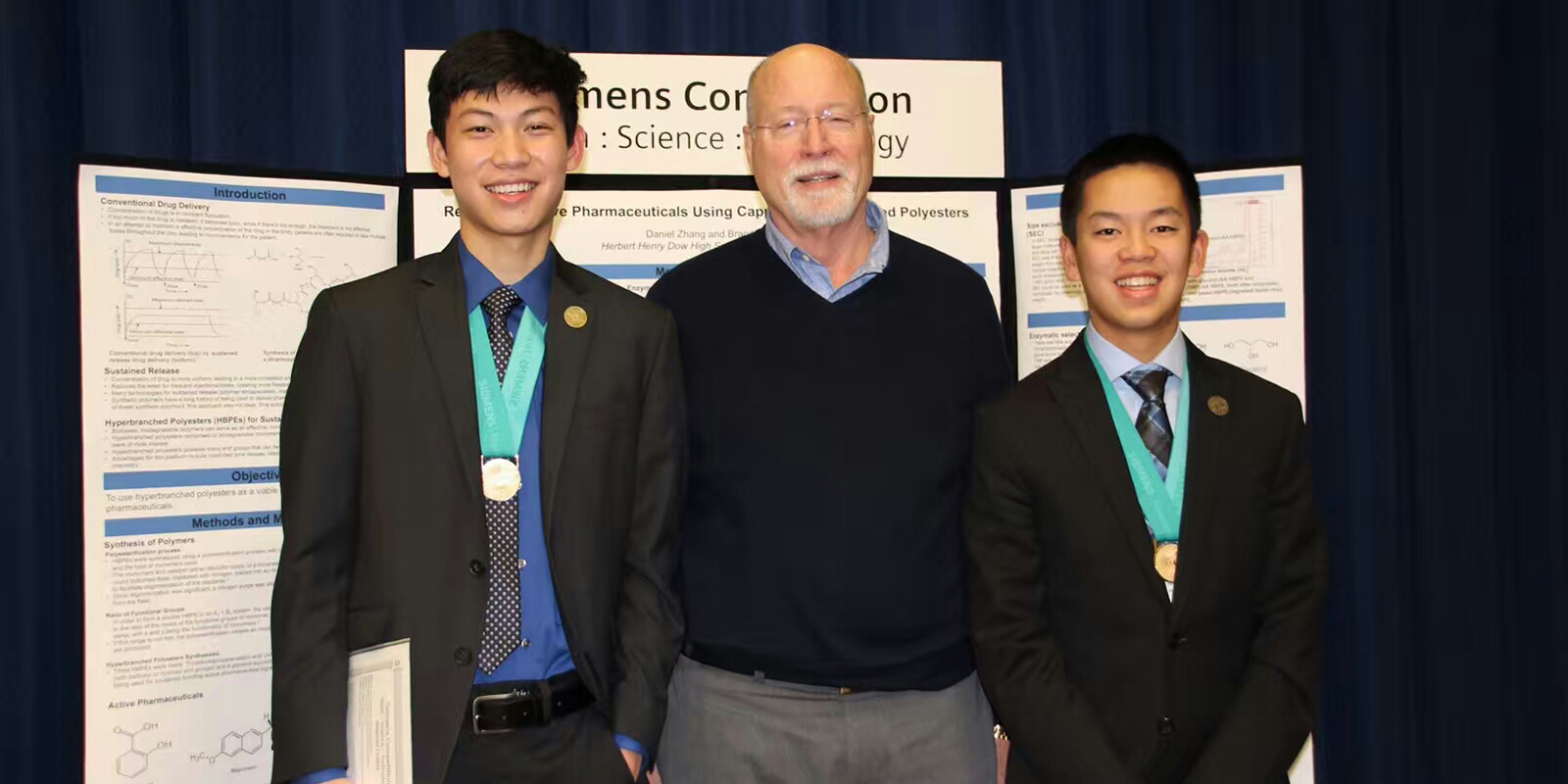 Group photo with two students and mentor at science competition