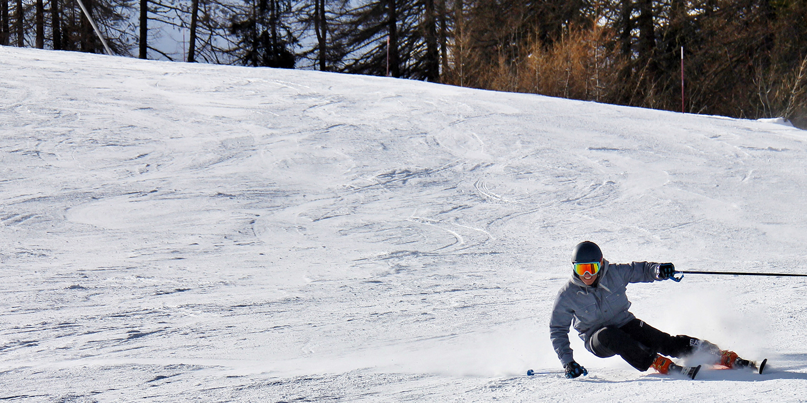 Man skiing downhill on a sunny day