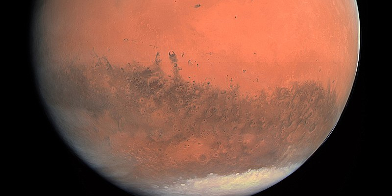 Image of The planet Mars with visible Martian polar ice caps.