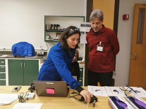 Image of scientist demonstrating Vernier sensor. 